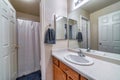 Vanity with sink inside bathroom with door that leads to the toilet and bathtub