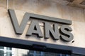 Vans logo and text sign front of clothing fashion store of american footwear skating Royalty Free Stock Photo