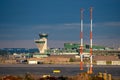 Helsinki-Vantaa Airport terminal building and air traffic control tower during the sunset against stormy clouds. Royalty Free Stock Photo