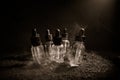 Vape concept. Smoke clouds and vape liquid bottles on dark background. Light effects. Useful as background or vape advertisement. Royalty Free Stock Photo