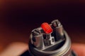 Vaping device with a hot spring on a black background for evaporation. Royalty Free Stock Photo