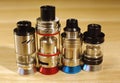 Vaping rebuildable dripping and tank atomizers RDTA, RTAon wooden surface close up Royalty Free Stock Photo