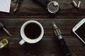 Vaping set, watch, coffee and smartphone on the wooden background. Hipster or bussinesman style.