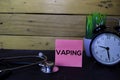 Vaping write on sticky notes isolated on wooden table. Medical or Healthcare concept