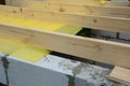 Vapor barrier installation on house roof. Roofing construction wooden beams, trusses with vapor barrier against leaking roof Royalty Free Stock Photo