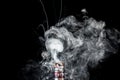 Vaporizer tank with cloud of smoke Royalty Free Stock Photo