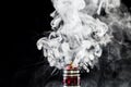 Vaporizer tank with cloud of vapor Royalty Free Stock Photo