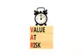 VAR Value at risk symbol. Concept words VAR Value at risk on beautiful wooden block. Black alarm clock. Beautiful white table Royalty Free Stock Photo