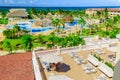 Beautiful view of resort grounds, swimming pools with people relaxing and enjoying their vacation leisure time in background