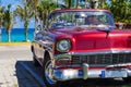 American red convertible 1956 vintage car parked direct on the beach in Havana Cuba - Serie Royalty Free Stock Photo