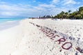 VARADERO written on a sandy beach as ocean. Varadero, Cuba. name of the resort town on white sand lined with seaweed Royalty Free Stock Photo