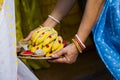 Varan ritual is being performed with boron dala by Indian woman in traditional attire. Boron dala is used for welcoming or Royalty Free Stock Photo