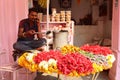 A men selling flowers on a local Indian market