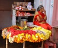 A woman selling flowers on a local Indian market