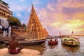 Varanasi Ganges river bank with view of an old man meditating at sunrise