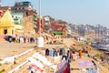 Varanasi Ganges river ghat with ancient city architecture as viewed from a boat on the river at sunset