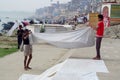 Varanasi ghats people washing clothes on the street on the banks of the river Ganges