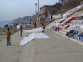 Varanasi ghats people washing clothes on the street on the banks of the river Ganges