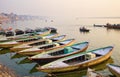 Varanasi, India: Bunch of old wooden colorful boats docked in the bay of Ganges river bank during sunset Royalty Free Stock Photo