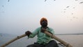 Varanasi, India - December 18, 2017: floating on Ganga river at early morning. Boatman rowing oars.