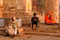 Indian man reading news in morning newspaper on the varanasi ghat