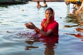 Varanasi, India, 27 Mar 2019 - Hindu woman in sari making offering to the gods in Ganga river at Varanasi, India Royalty Free Stock Photo