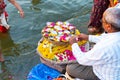 Varanasi, India, 27 Mar 2019 - Indian man selling pooja flowers items for the offering Royalty Free Stock Photo