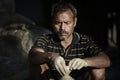 Indian man is sitting using his hands to sculpt the clay on a rotating tray to make a clay bowl Royalty Free Stock Photo