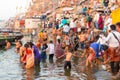 Varanasi, India, 27 Mar 2019 - Showing the colorful traditional clothing and Hindu religious ritual of bathing in the Royalty Free Stock Photo