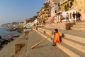 Man playing Didgeridoo on ganga river bank in morning. Varanasi. India