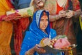 Women pilgrims pray at the bank of the Holy Ganges river at sunrise in Varanasi, India.