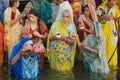 Women pilgrims pray at the bank of the Holy Ganges river at sunrise in Varanasi, India.