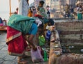 Varanasi, India: Bunch of women in saree putting diya candle around holy pond performing ritual prayer at the Royalty Free Stock Photo