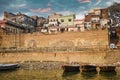 Varanasi, India: Bunch of wooden boats docked on river Ganges against a wall with graffiti art and old