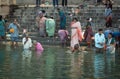 Varanasi, India : Hindu Family and friends take an early morning dip in the Ganges at Varanasi to pray and wash Royalty Free Stock Photo