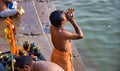 Varanasi, India : A hindu man blowing shankh translates to sea shell conch as a gesture of prayer ritual next