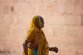 Varanasi, India, 20 november, 2019 / Indian woman wearing colorful, traditional indian sari, walking down the road Royalty Free Stock Photo