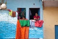 Varanasi, India, 15 november, 2019/ Mother and son at the window of a colorful building in front of the river ganges. Indian