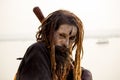 Varanasi, India - November 01, 2016: Portrait of a male hindu sadhu baba aghori pilgrim with dreadlock against ganges river Royalty Free Stock Photo