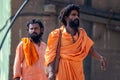 Varanasi, India, 15 november, 2019 / two Indian yogi or sannyasi men, of hinduist religion, dressed in orange with rasta hair,