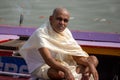 Varanasi, India, 15 novembre, 2019/ Life on the Ganges: indian boatman sitting on his boat, lookingat camera