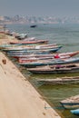 VARANASI, INDIA - OCTOBER 25, 2016: Small boats near Ghats riverfront steps leading to the banks of the River Ganges in Royalty Free Stock Photo