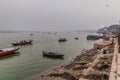 VARANASI, INDIA - OCTOBER 25, 2016: Small boats near Ghats riverfront steps leading to the banks of the River Ganges in Royalty Free Stock Photo