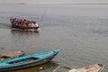 VARANASI, INDIA - OCTOBER 25, 2016: Small boats near Ghats riverfront steps leading to the banks of the River Ganges in Royalty Free Stock Photo