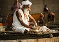 Varanasi, India: Portrait of a hindu white bearded old man sadhu, pilgrim in white clothes and turban sitting