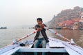 16.12.2019 Varanasi, India. Portrait of an Indian male boatman who paddles while transporting a passenger. View from the boat. In