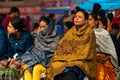 17.12.2019, Varanasi, India. The sacred religious ceremony of Arati. A group of women sits and watches a religious action