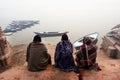 VARANASI, INDIA: Silhouettes of three men watch the river Ganges