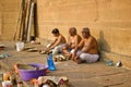 Varanasi, India: Wide angle shot of three hindu brahmin or priest or men in dhoti sitting together performing