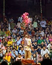 Priest throwing flower petals during Ganga aarti on banks of holy river Ganges in one of the oldest living cities of World and Royalty Free Stock Photo